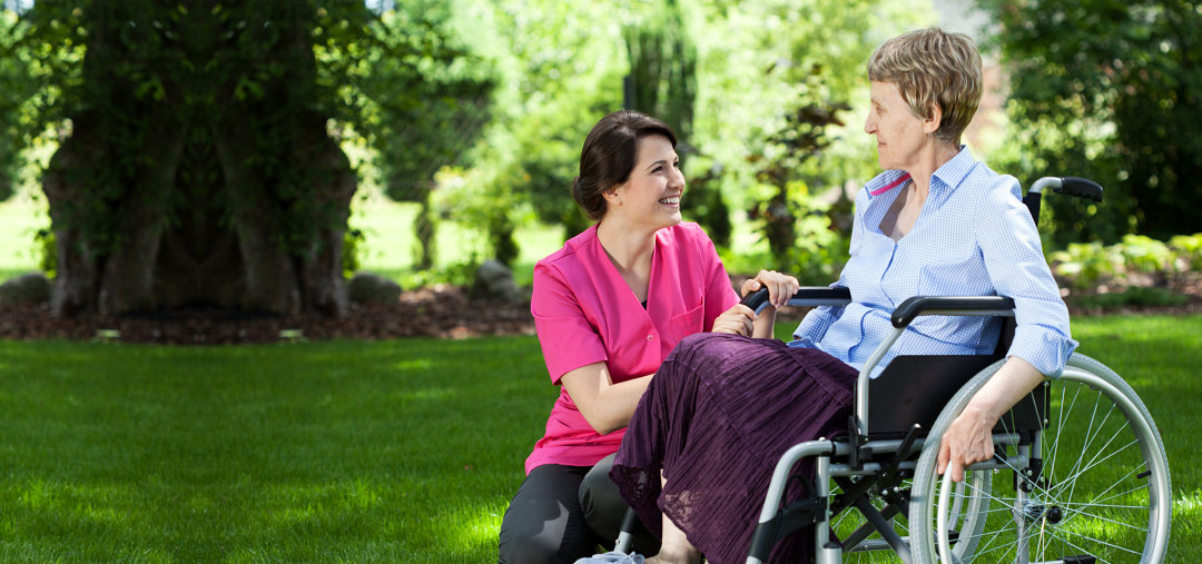 caregiver and elderly in a wheelchair